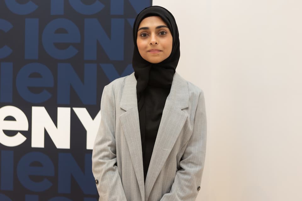 Student learning in New York City classroom and cityscape